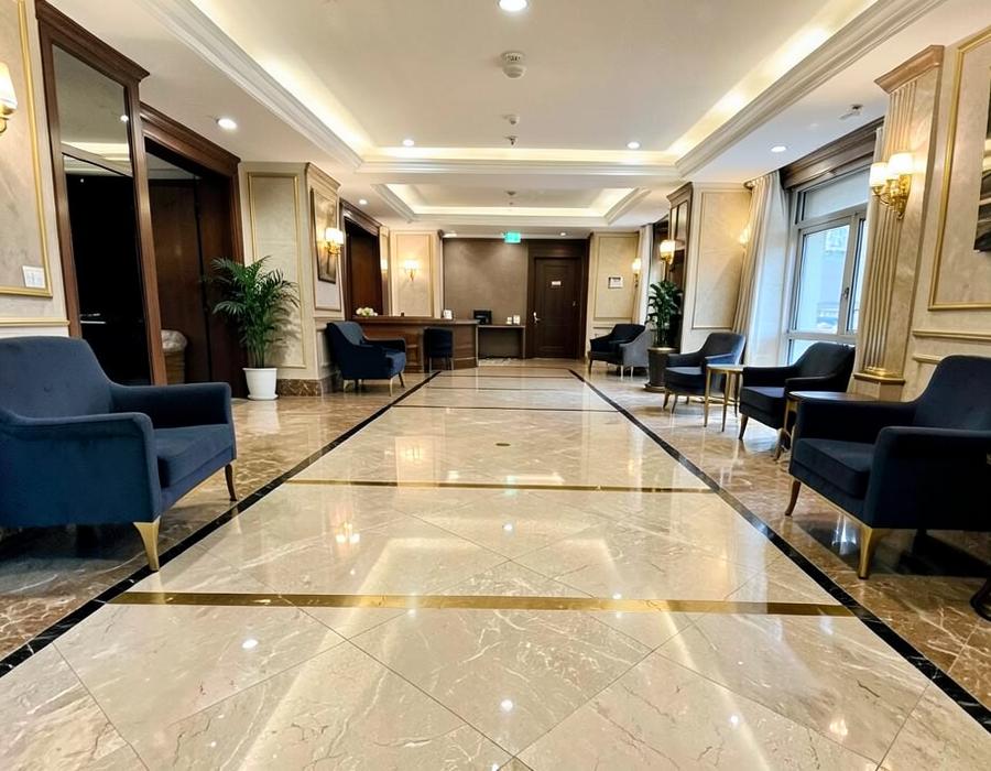 Hotel lobby with stone-effect tiled floor and gold detailing
